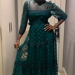 Green dress with green dots.